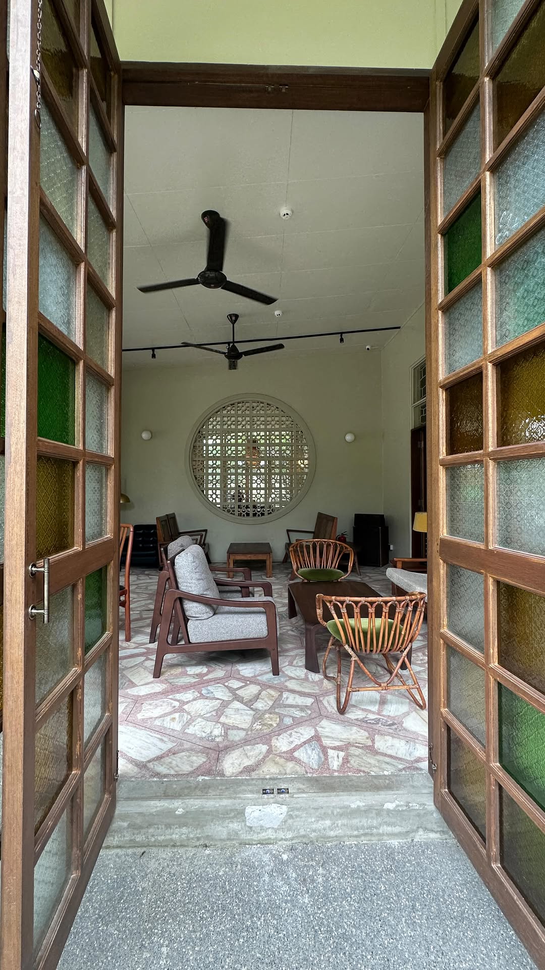 Lewis House interior entry with stained glass panels and circular window